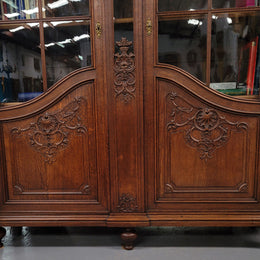 Substantial French Oak Louis 15th Style large two door bookcase. Adjustable shelves and very decorative carving. In good original detailed condition.