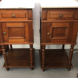 A lovely pair of French Oak, marble top bedside cabinets with a cupboard and drawer in good original condition.
