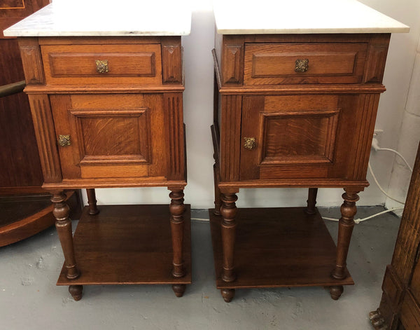 A lovely pair of French Oak, marble top bedside cabinets with a cupboard and drawer in good original condition.