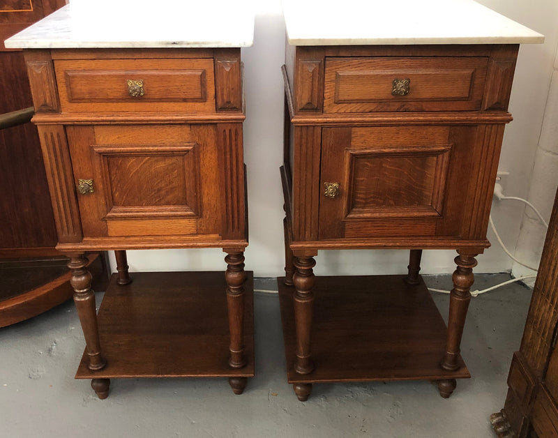 A lovely pair of French Oak, marble top bedside cabinets with a cupboard and drawer in good original condition.