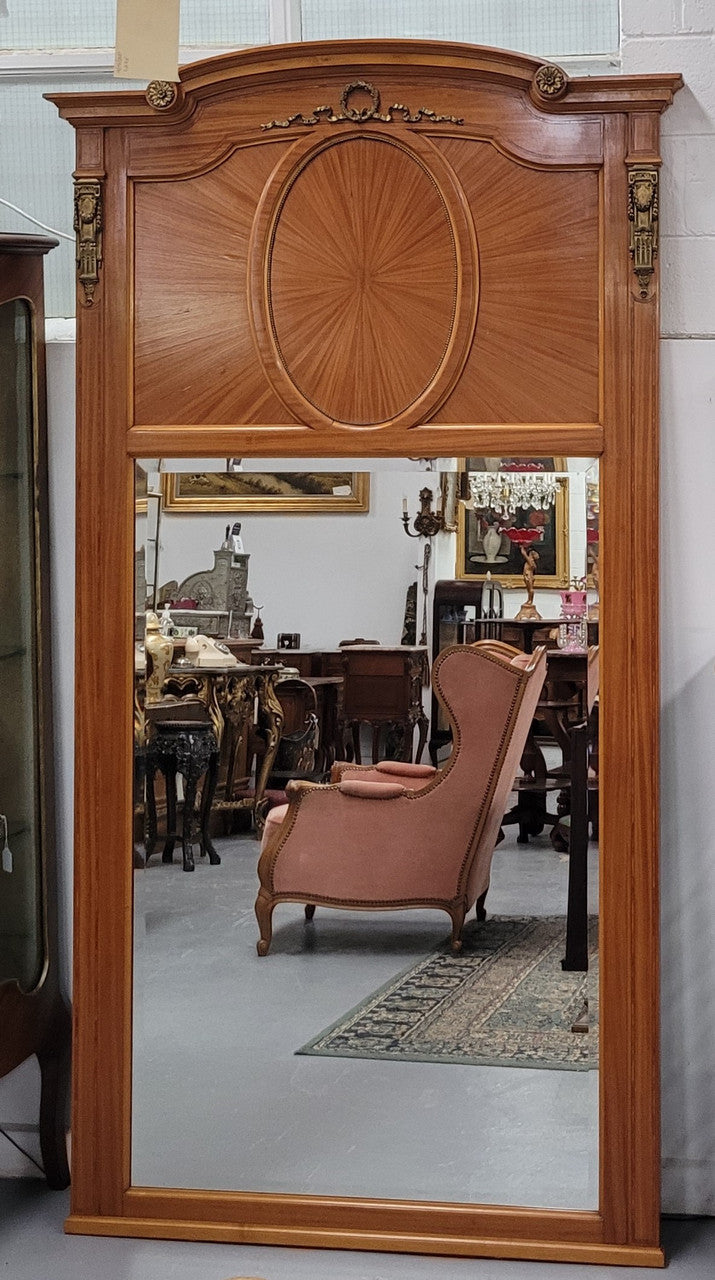 Stunning long Louis XV style satinwood Trumeau mirror decorated with Bronze ormolu mounts. It has its original bevelled mirror and it in good detailed condition. It has been sourced from France.