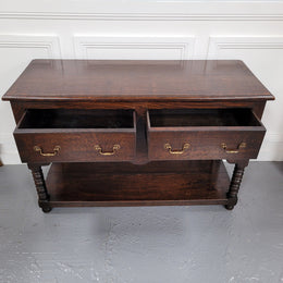 Rare size 19th Century English oak dresser base. It has two good size drawers and amazing patina. It has been sourced from France and in good original detailed condition.