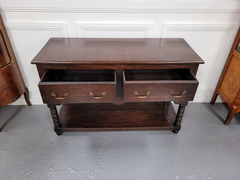 Rare size 19th Century English oak dresser base. It has two good size drawers and amazing patina. It has been sourced from France and in good original detailed condition.