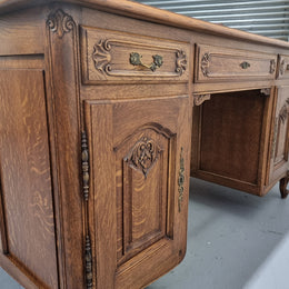 Fabulous French oak carved partners desk with a lovely parquetry top. It has three drawers and two cupboards on one side and two cupboards on the other side with no functioning drawers. It is in good original detailed condition.