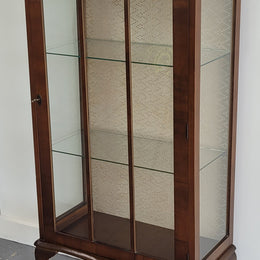 Petite single door Walnut display cabinet. Art Deco style with glass display door and two fixed shelves. In original condition.