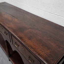 Antique 19th Century English dark Oak three drawer Dresser with brass handles and in good original condition.