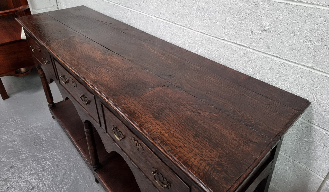 Antique 19th Century English dark Oak three drawer Dresser with brass handles and in good original condition.