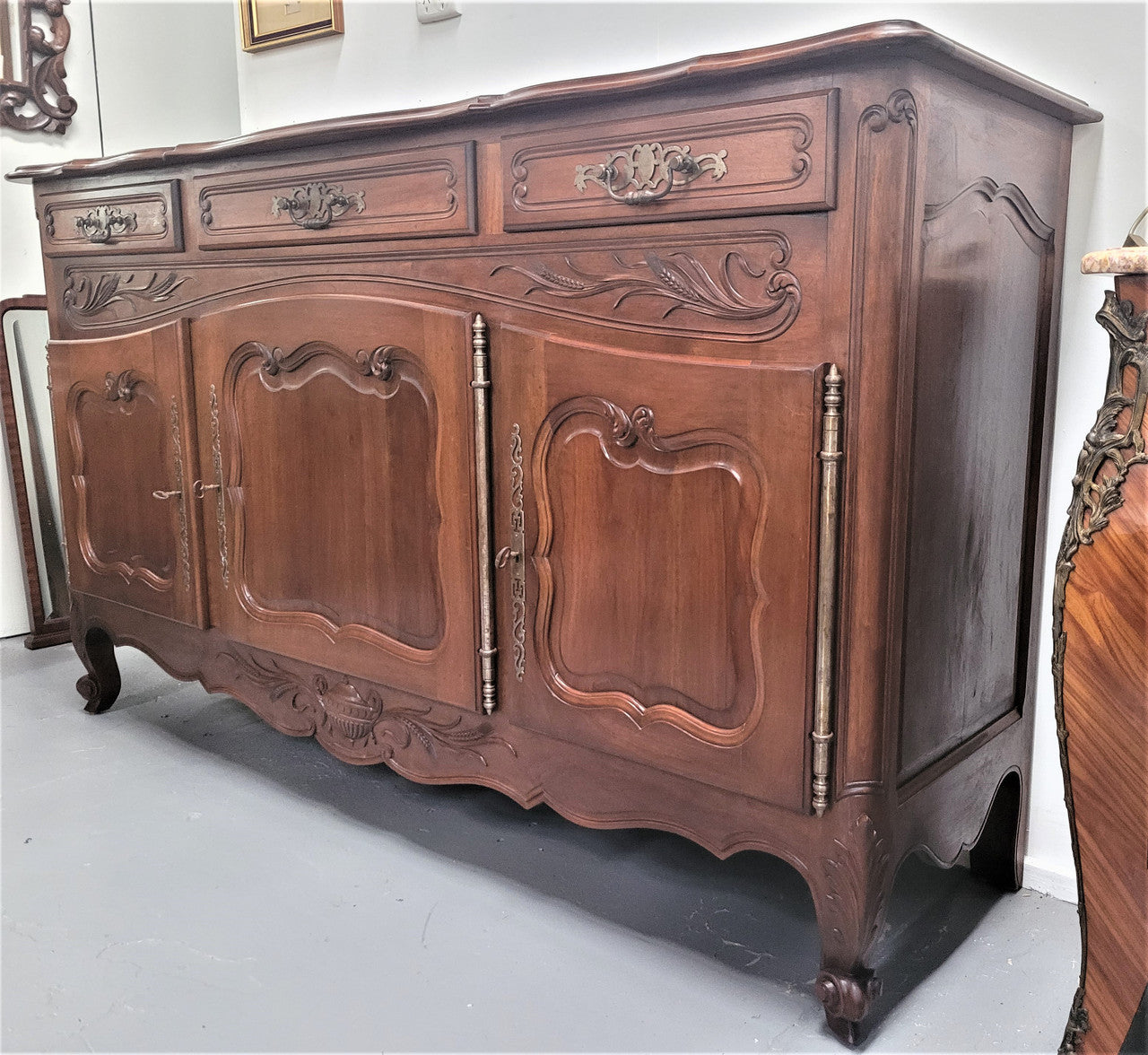 Louis XV style Walnut sideboard with three drawers and three doors. In good original detailed condition.