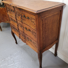 Vintage French dark Oak Louis XV style chest of three drawers. It has beautiful cabriole legs, elegant brass handles and decorative carving throughout. It is in good original detailed condition and has been sourced from France.