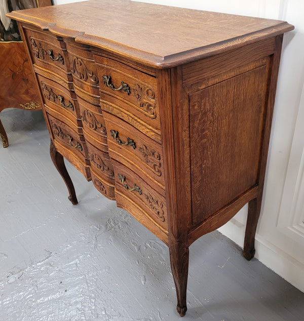 Vintage French dark Oak Louis XV style chest of three drawers. It has beautiful cabriole legs, elegant brass handles and decorative carving throughout. It is in good original detailed condition and has been sourced from France.