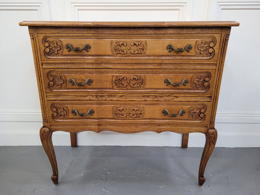 French Oak Louis 15th style nicely carved three drawer wooden top commode. It has been sourced from France and is in good original detailed condition.