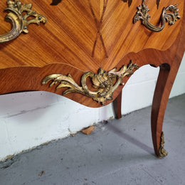 Charming petite French Louis XV style commode featuring two drawers, marquetry inlay, ormolu trim and marble Top. In good original detailed condition.  Circa: 1930’s.