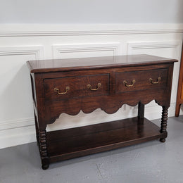 Rare size 19th Century English oak dresser base. It has two good size drawers and amazing patina. It has been sourced from France and in good original detailed condition.