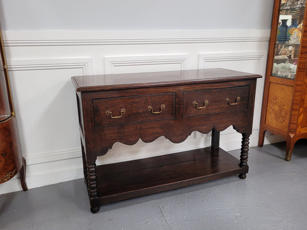 Rare size 19th Century English oak dresser base. It has two good size drawers and amazing patina. It has been sourced from France and in good original detailed condition.