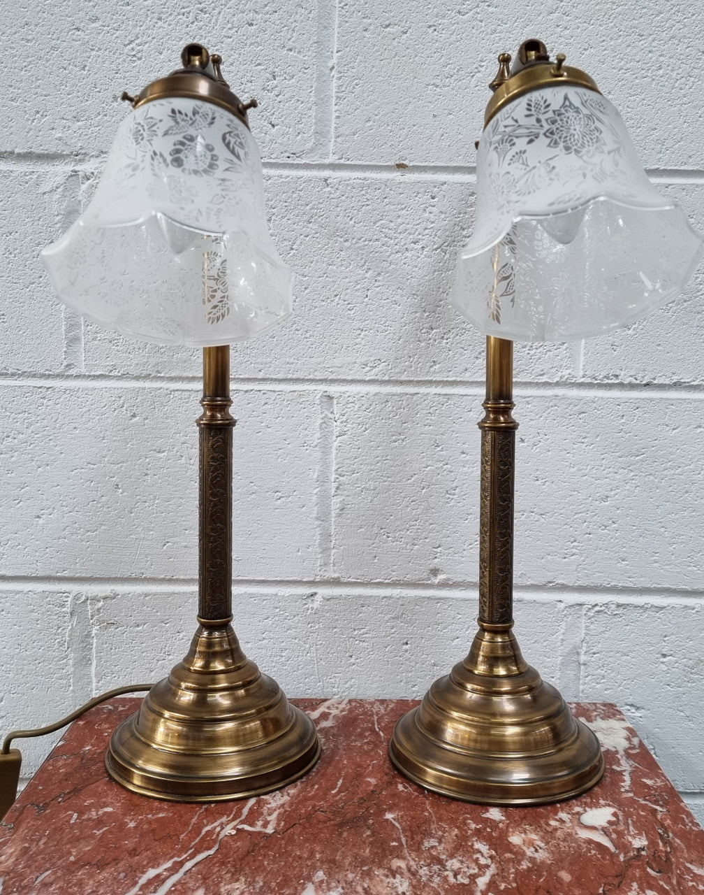 Pair of tall Antique style table lamps with glass floral etched shades. They have been sourced locally and are in good original detailed working condition.