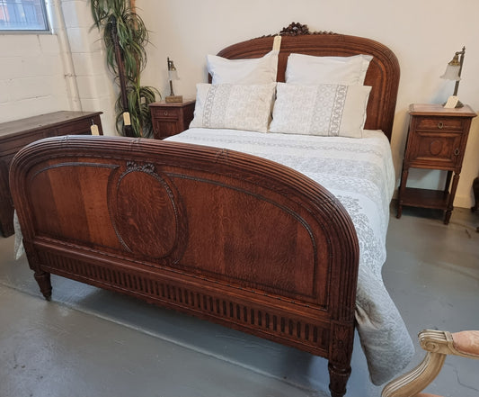 Elegant Louis XVI style French Oak queen size bed with a pair of matching inset marble top bedsides. The queen size beed comes with custom made bed slates and all you need to do is place your mattress on top. Bedsides and bed are in good original detailed condition.