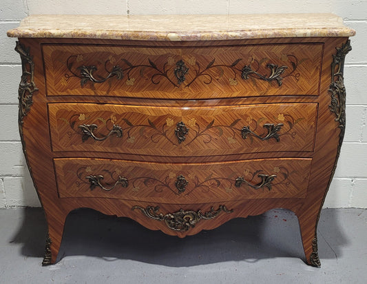French three drawer marquetry inlaid marble top commode with decorative ormolu mounts. In good original detailed condition.
