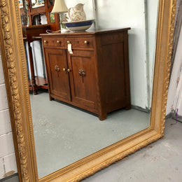 Very large French style mirror with beveled glass. In very good original condition.