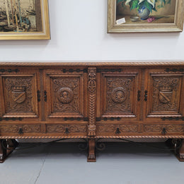 Large French Oak Renaissance style four door sideboard/buffet. Great decorative item with amazing carvings and stunning iron work on base. It is in good original detailed condition. Can pull apart completely making it easier to move.