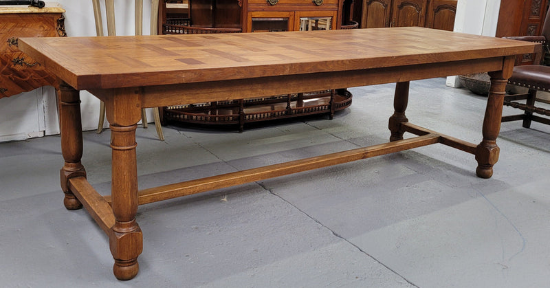French Oak Refectory dining table with a parquetry top. Sourced from France this table comfortably sits eight to ten. It is in good original detailed condition.