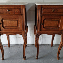 Lovely pair of French Oak bedside cabinets with marble tops, cupboard and drawer. In good detailed original condition.