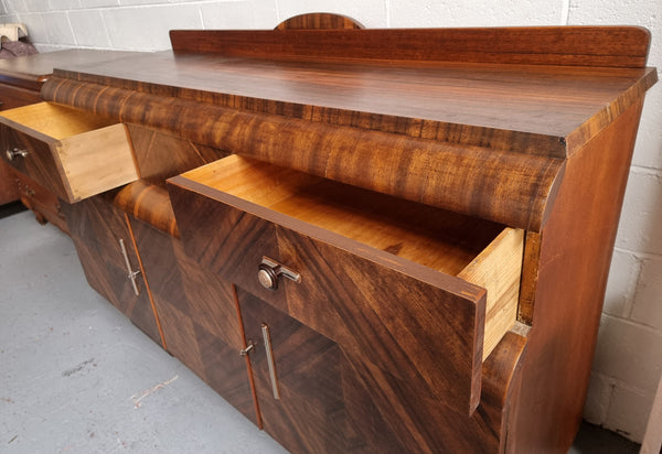 Vintage Walnut Art Deco “Waterfall” sideboard buffet with two drawers and two doors. It is in good original condition and has been sourced locally.