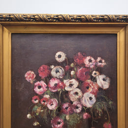Antique French floral oil on canvas in gilt frame that is signed lower right corner. It has been sourced from France and is in good original detailed condition.