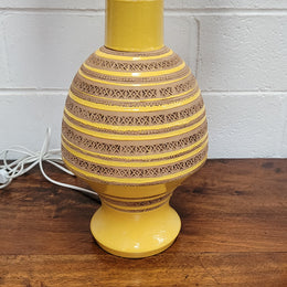 A large and impressive Vintage Mid-Century Bitossi Italian terra cotta lamp base and shade. Incised repeating geometric terra cotta pattern creates a tactile element which is incorporated with stunning shining thick yellow glaze to create the sculptural form of the base.