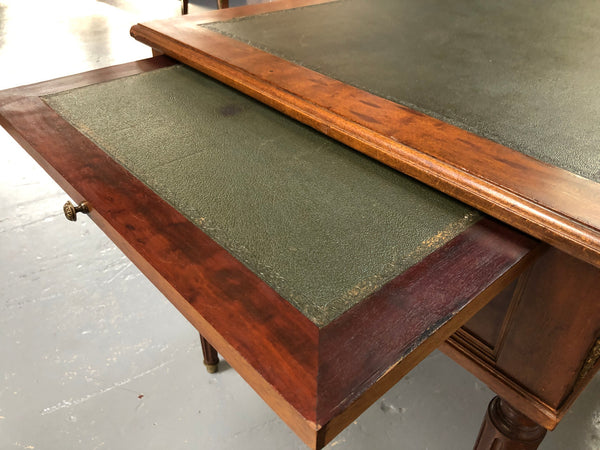 Lovely French Mahogany Louis XVI style leather top desk. With beautiful ormolu details and three drawers. There are also two slides on either side with tooled leather tops and in good original detailed condition.