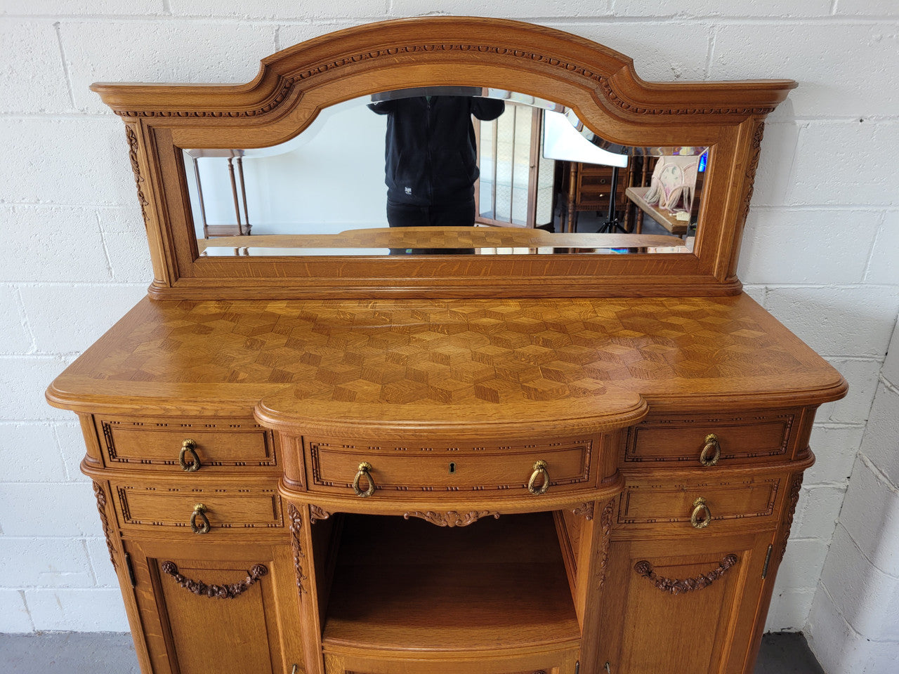 Beautiful French Oak Louis XVI Style nicely carved sideboard with a lovely parquetry top and mirror. It has five drawers and three cupboards for all your storage needs. In good original detailed condition.