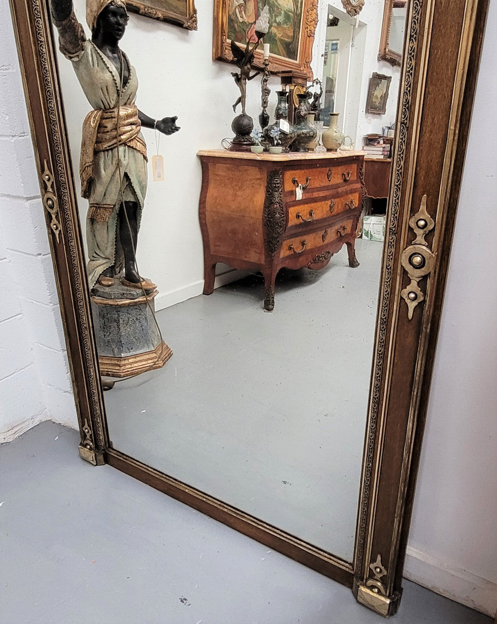 Early 19th Century French gilt and simulated wood mantel mirror. It still contains its original glass which contains loads of character. It is in very good detailed condition and has had minor restorations.
