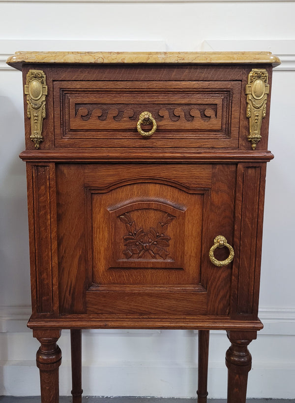 French Oak pair of Louis 16th style marble top bedsides with stunning bronze mounts. They have been sourced from France and are in good original detailed condition.