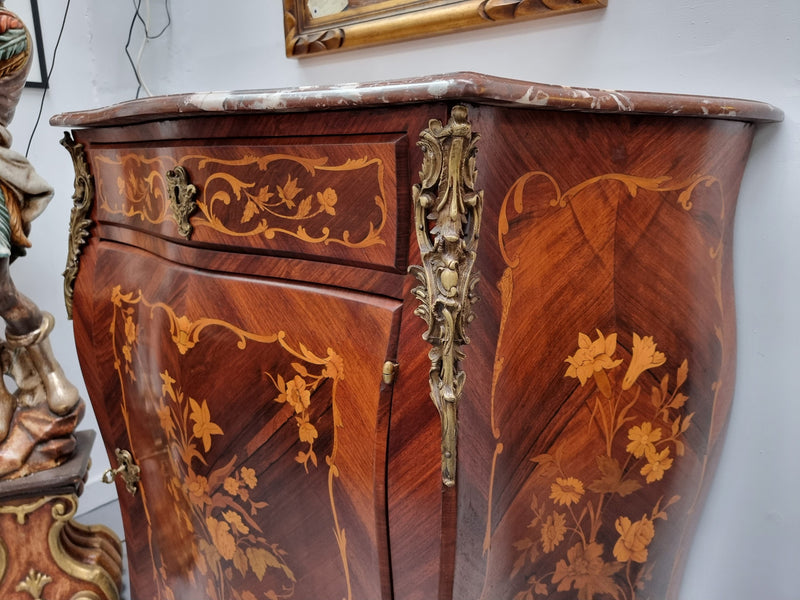 Stunning French Transitional style Mahogany marquetry inlay salon cabinet in the bombe shape. It has one draw, one shelf, marble top & ormolu decoration. Sourced from France and in good original detailed condition.