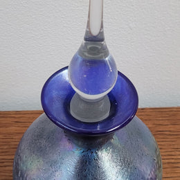 Stunning iridescent hand blown perfume bottle. Beautiful peacock blue, purple colours. Signed on base with clear glass stopper.