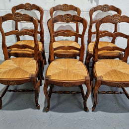 Set of six French Cherrywood rush seat dining chairs. In good restored condition.
