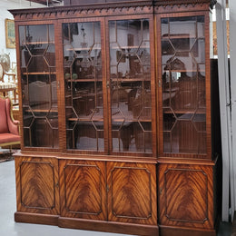 Georgian style Breakfront Flame Mahogany four door bookcase. A very impressive piece with plenty of storage and is of pleasing narrow proportions. It has been sourced locally and is in good original detailed condition.