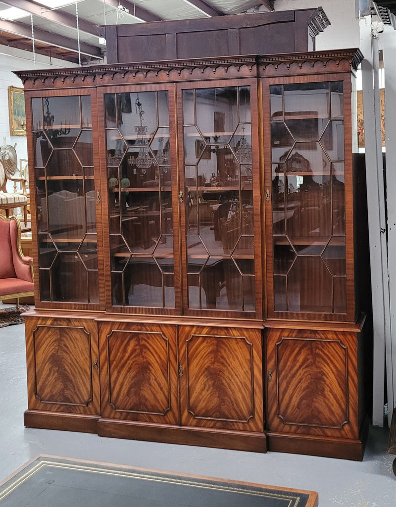 Georgian style Breakfront Flame Mahogany four door bookcase. A very impressive piece with plenty of storage and is of pleasing narrow proportions. It has been sourced locally and is in good original detailed condition.