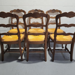 A set of 6 French Louis XV style oak dining chairs with rush seats in good original condition. All chairs have been detailed and re-glued where needed.