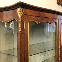19th Century ornate French Walnut marquetry inlay display cabinet. Has beautiful ornate ormolu mounts and its original glass. In good original detailed condition.
