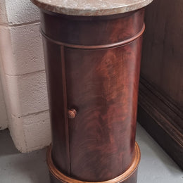 Unusual Empire flame Mahogany cylindrical marble topped bedside/pedestal. Would make an ideal pedestal with added storage inside or could be used as a bedside. Sourced from France and is in good original detailed condition.