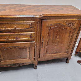 French Oak Louis XV style three door, two drawer, parquetry top sideboard. It has been sourced from France and is in good restored condition.
