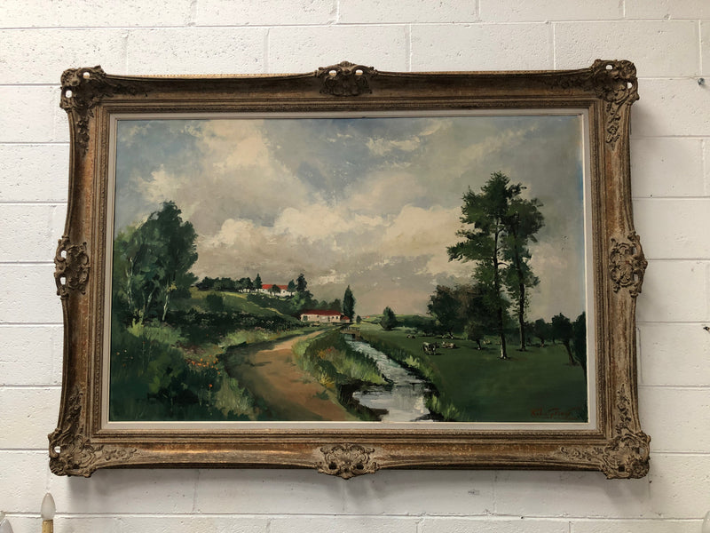 Lovely framed French signed oil on canvas of a country scene in a ornate decorative frame and is in good original condition.