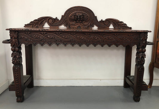 Superb 19th Century Gothic style hall/console table. It has umbrella and walking stick holders on both sides. In good original detailed condition.