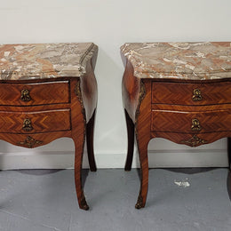 Pair of Louis XV commode style two drawer bedsides with beautiful marble tops and decorative mounts. They are a rare size and are in good, detailed condition.