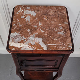 French Rosewood inset marble top single bedside cabinet with one drawer and one cupboard on elegant legs. Would also make a practical and stunning table lamp. It is in good original detailed condition.