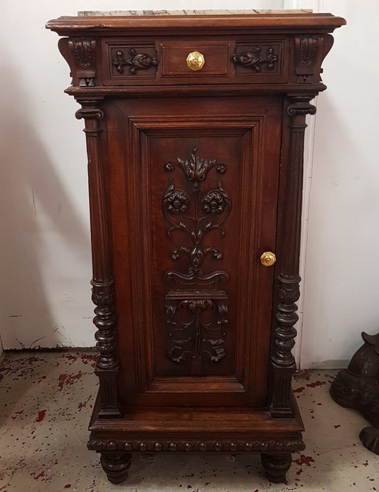 A French Henry II style, single walnut bedside cabinet, with finely carved detailing, a inset marble top, a drawer and cupboard with three shelves in good original condition.