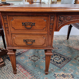 Substantial French Louis XVI style Oak partners desk. It has a beautiful leather top, two drawers on either side and decorative carvings throughout. Sourced from France and in good original detailed condition.