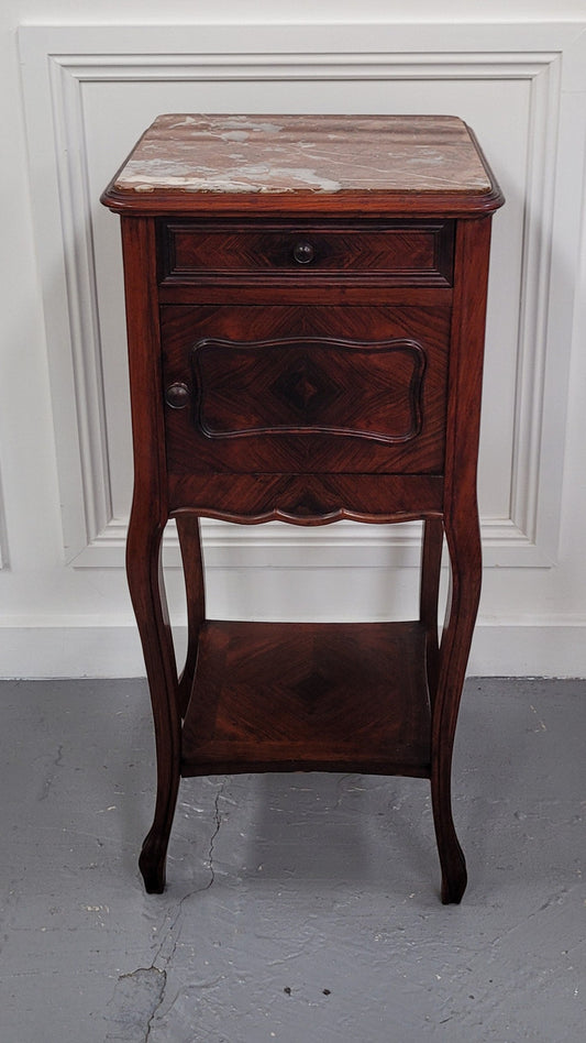 French Rosewood inset marble top single bedside cabinet with one drawer and one cupboard on elegant legs. Would also make a practical and stunning table lamp. It is in good original detailed condition.