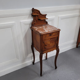 French Louis XV style Walnut single bedside cupboard with inset marble top. It has been sourced from France and is in good original detailed condition.