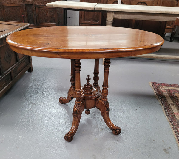 Victorian Walnut oval beautifully inlaid occasional table with bird cage undercarriage. It is in good original detailed condition and it has been sourced locally.